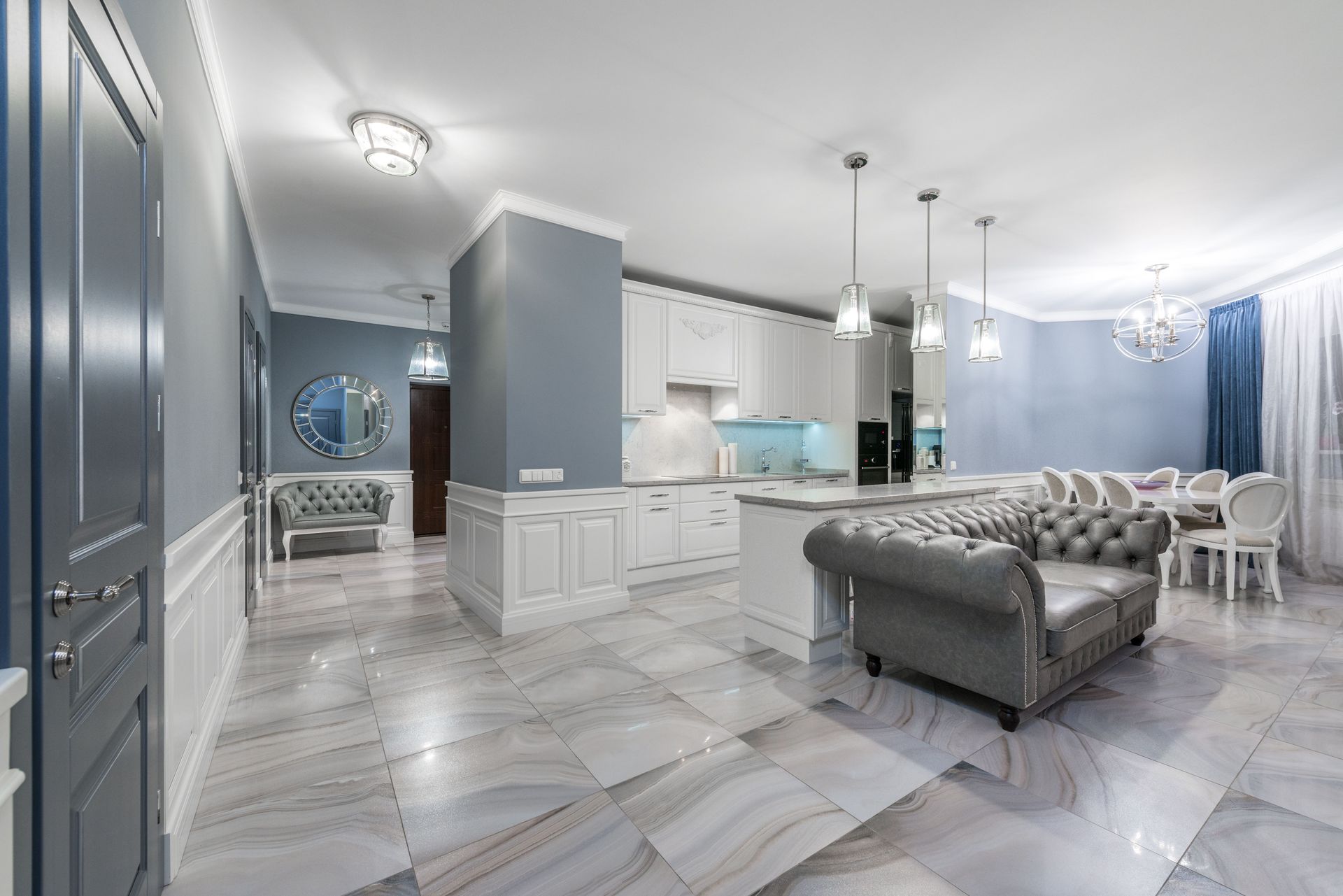 Bright open-concept kitchen and living area featuring modern design with stylish furniture and decor.